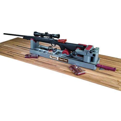 The Tipton Gun Vise securely holds your rifle or shotgun, featuring a rubberized cradle, quick release cam, and compartments for solvents, perfect for gunsmithing.